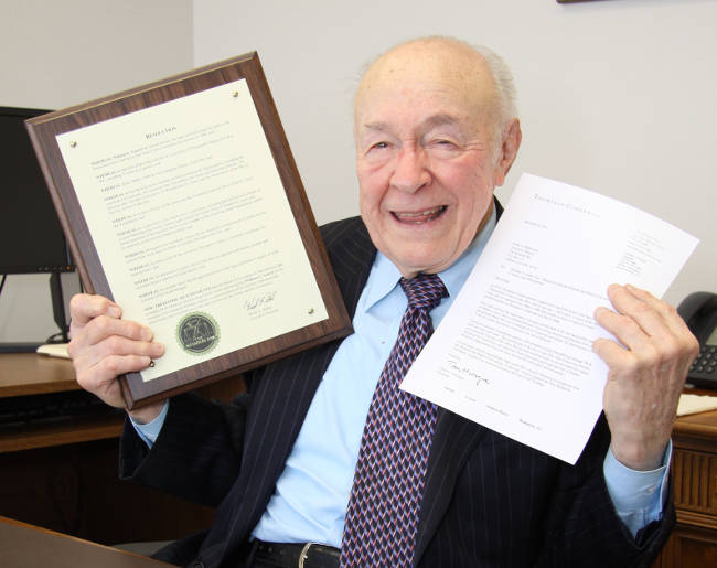 Bill Guerri displays his plaque and a nominating letter