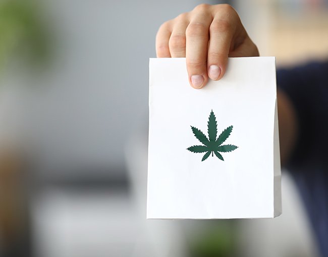 A delivery of cannabis products in a labelled paper bag