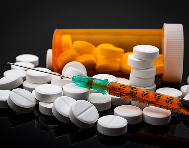 Opioid pills and needle