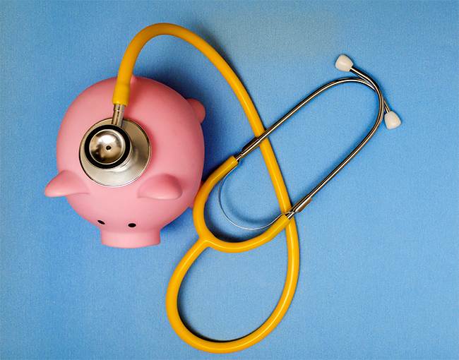 Piggy Bank sitting on top of a stethoscope