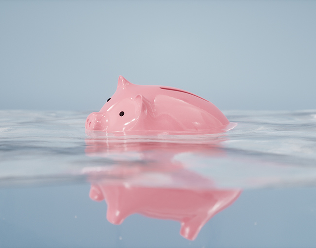 A piggy bank sinking in water