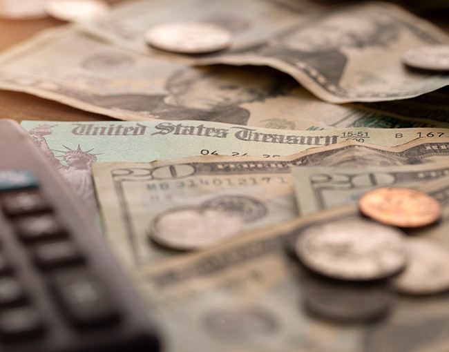 Money, a calculator and a U.S. Treasury document