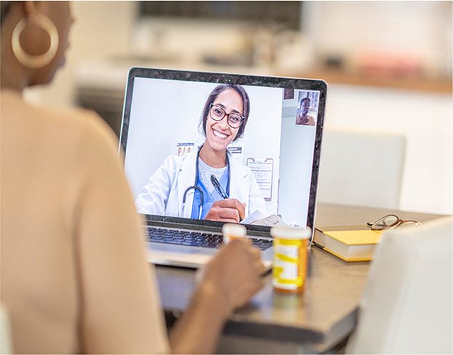 A woman talking to a doctor via a telehealth appointment