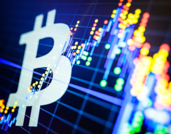 Bitcoin symbol against financial screen