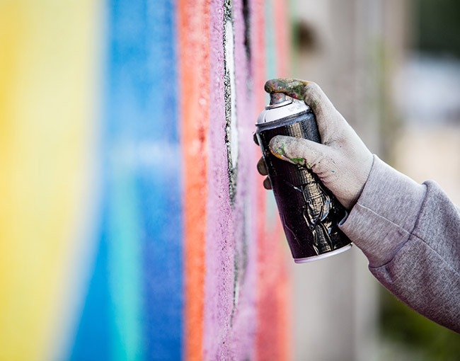 hand spraypainting a wall